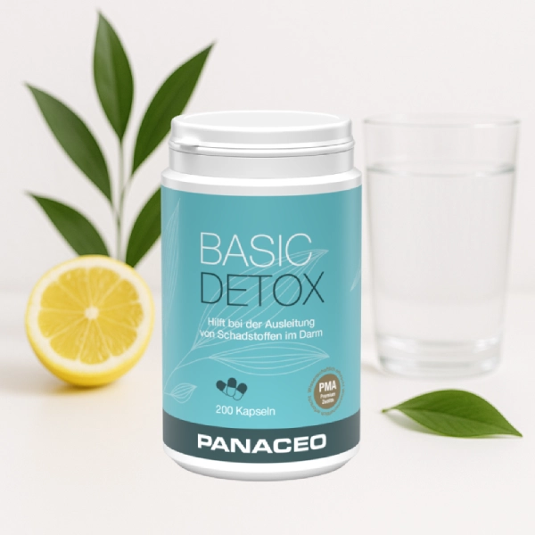 Produktabbildung Basic-Detox Kapseln mit Zitrone und Glas im Hintergrund